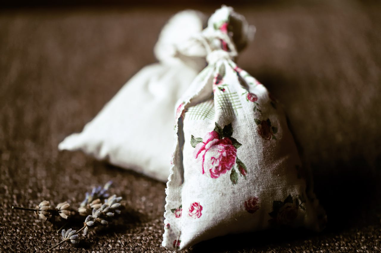 hero-img-02 Handcrafted floral lavender sachet on textured surface perfect for aromatic therapy and decoration.