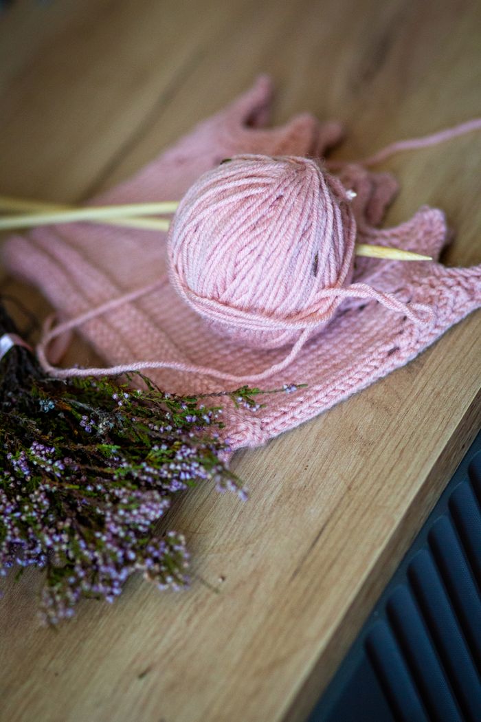gallery-4 Aesthetic arrangement of pink yarn and lavender on a rustic wooden surface, perfect for crafting inspiration.