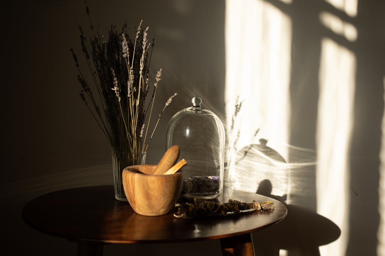 gallery-6 Elegant wooden mortar with vase and glass cloche in warm lighting, creating soft shadows.
